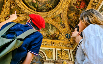 Visitors admire ornate ceiling art in Versailles Palace during a private guided tour.