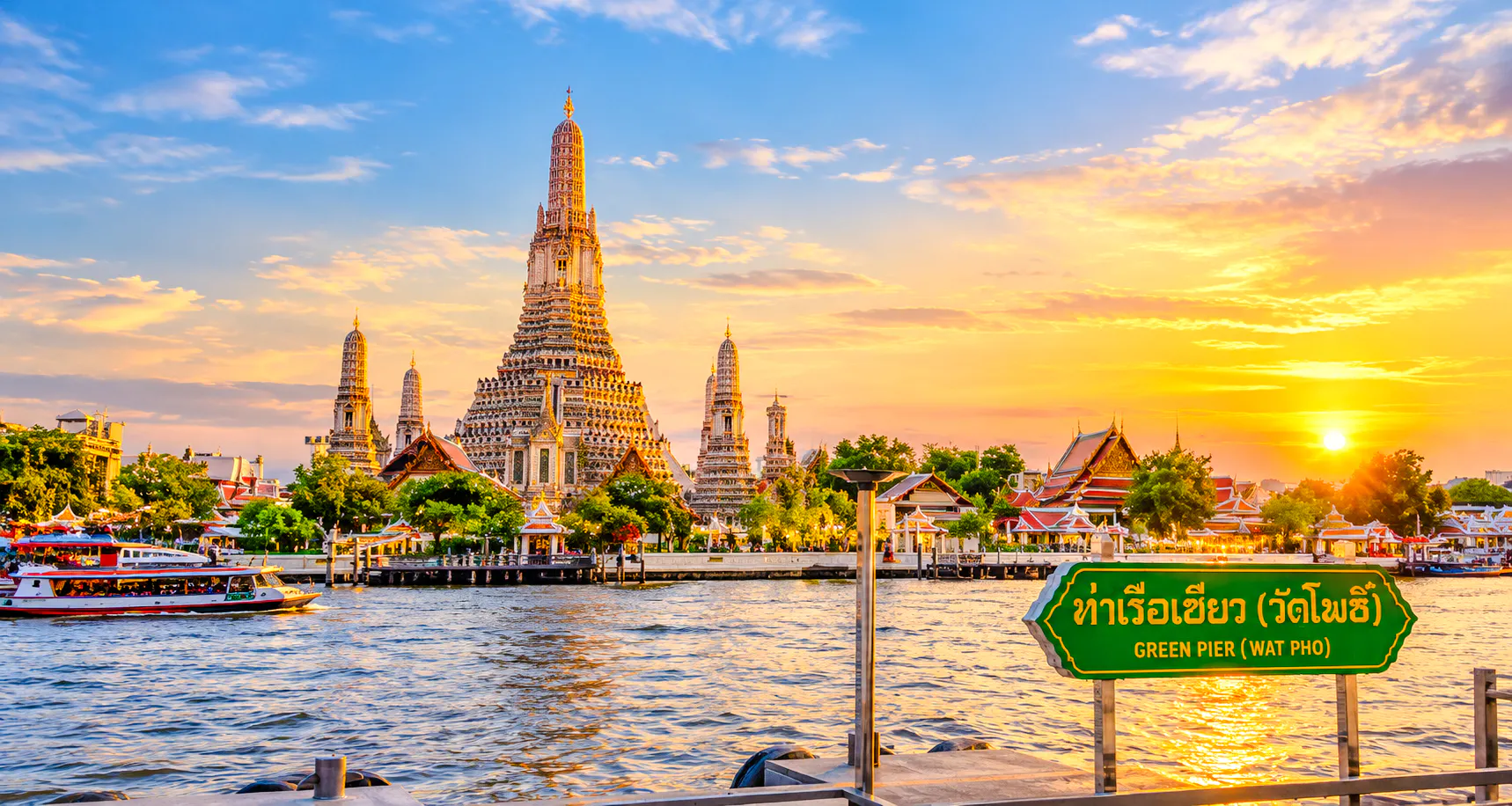 Wat Arun temple by the Chao Phraya River at sunset, Bangkok.