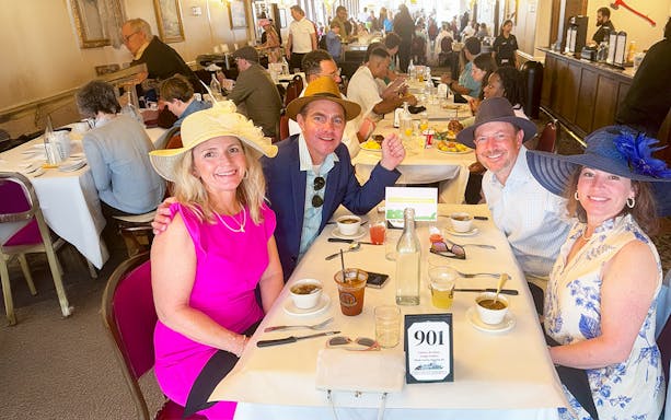 Guests enjoying brunch on Steamboat Natchez in a lively dining room.
