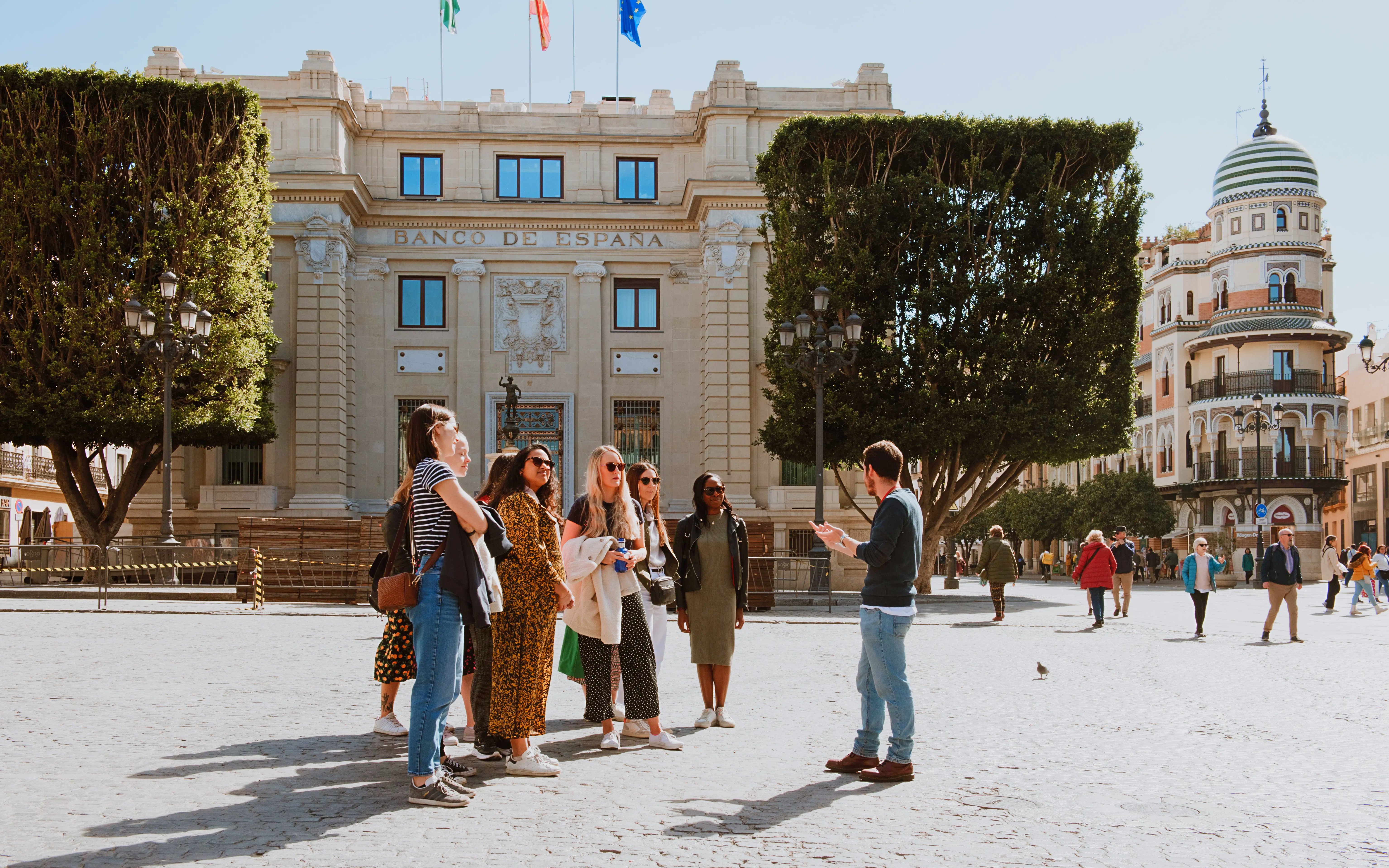 Group on a walking tour near Seville City Hall in Spain.