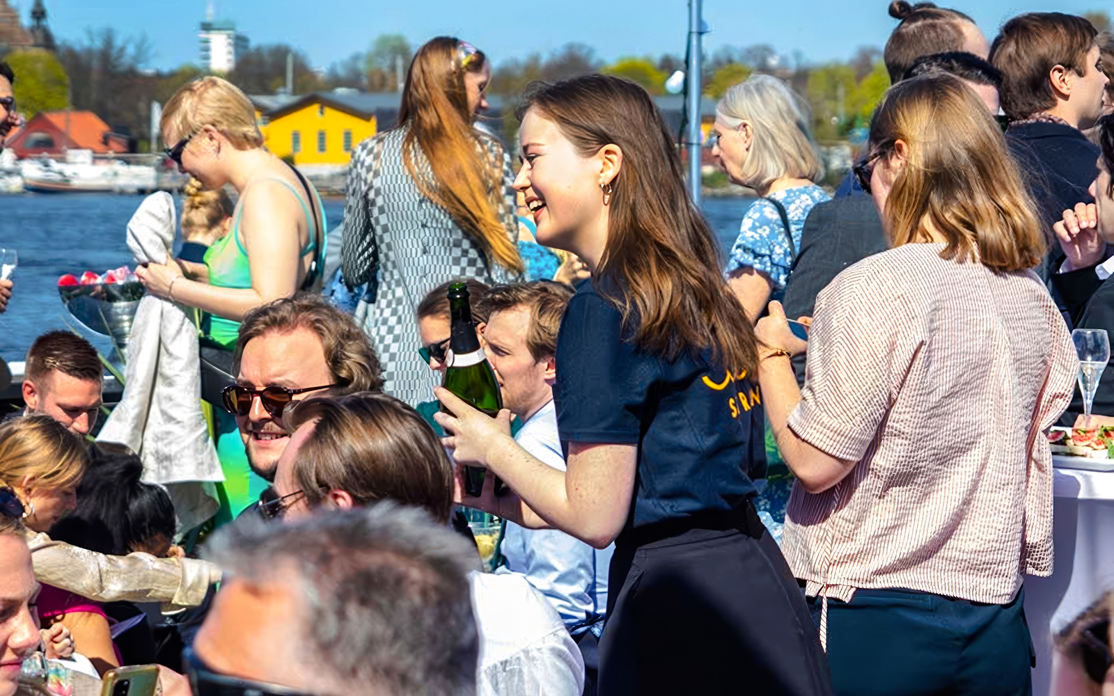 People enjoying Stockholm Harbor Archipelago Cruise with drinks and scenic views.