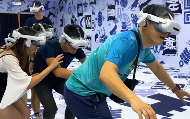 Visitors experiencing virtual reality tour, DaVinci and The Wheel of Time, with headsets.