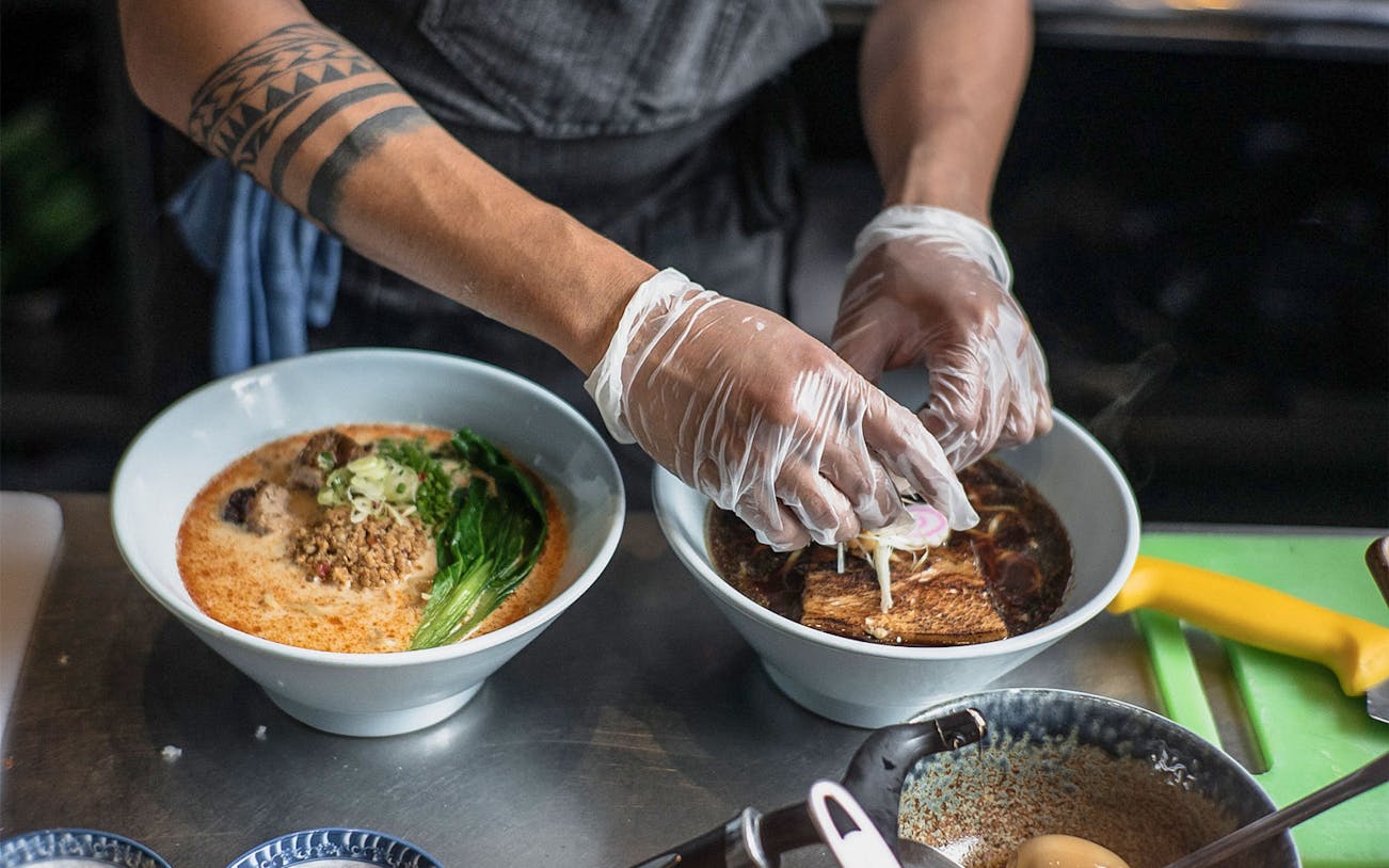 Chef preparing ramen bowls on Tokyo Ultimate Ramen Tasting Tour.