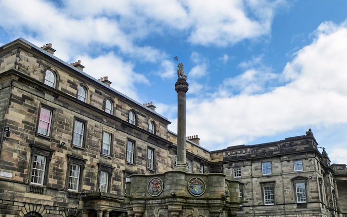 Mercat Cross with Royal Unicorn and heraldic medallions in Old Town, Edinburgh.