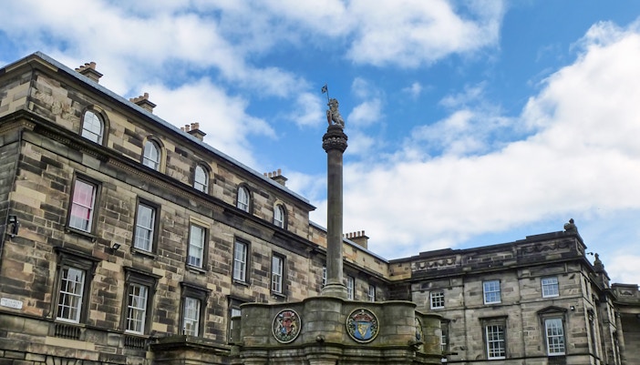 Mercat Cross with Royal Unicorn and heraldic medallions in Edinburgh's Old Town.