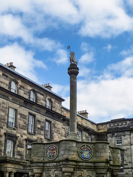 Mercat Cross with Royal Unicorn and heraldic medallions in Old Town, Edinburgh.