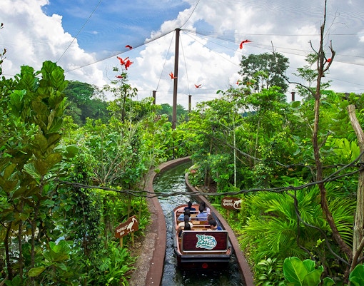Safari World Bangkok river safari boat tour with lush greenery and wildlife, Bangkok, Thailand.