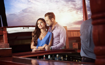 Couple enjoying a romantic sunset cruise in Cancun.