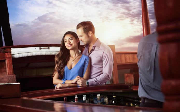 Couple enjoying a romantic sunset cruise in Cancun.