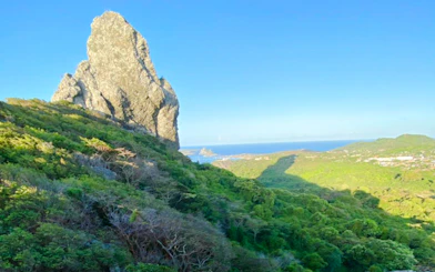 Noronha Piquinho Trail with ocean view and rocky peak, Sao Paulo.