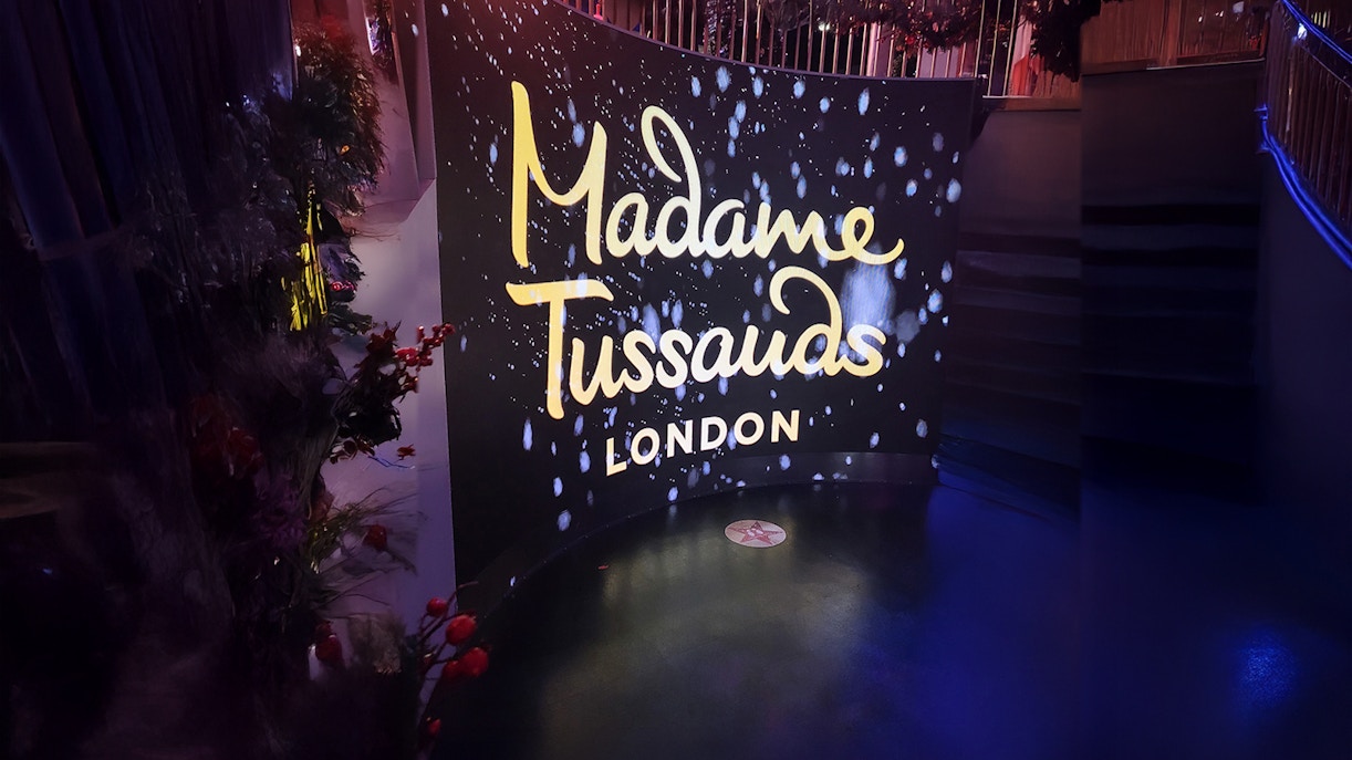 Large plasma at entrance screen with neon lighting reading "Madame Tussauds London"