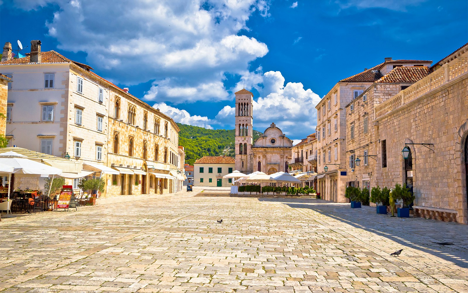 Pjaca Square with church and historic buildings in Hvar, Croatia.
