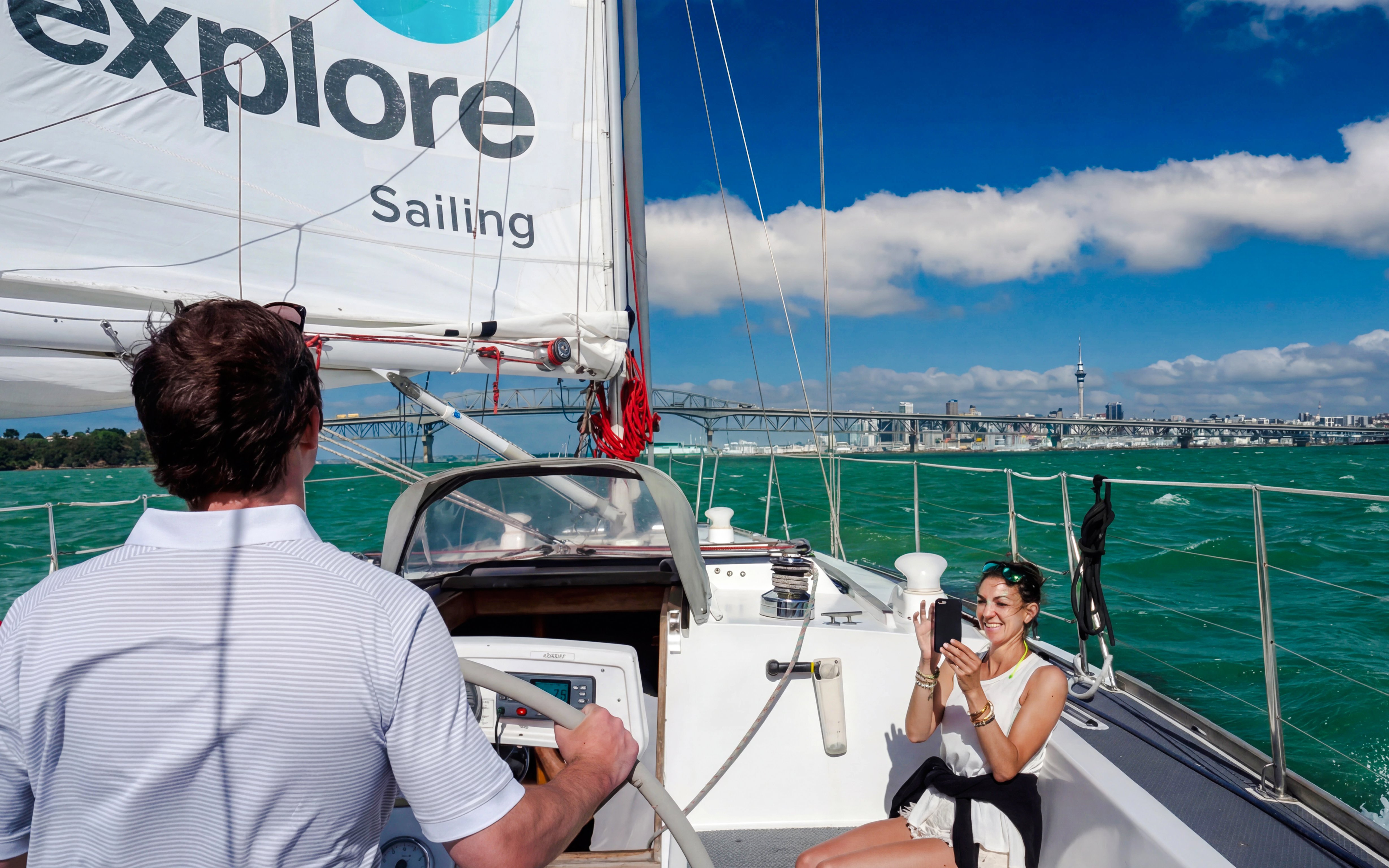 Sailing cruise on Waitematā Harbour with Auckland skyline in the background.