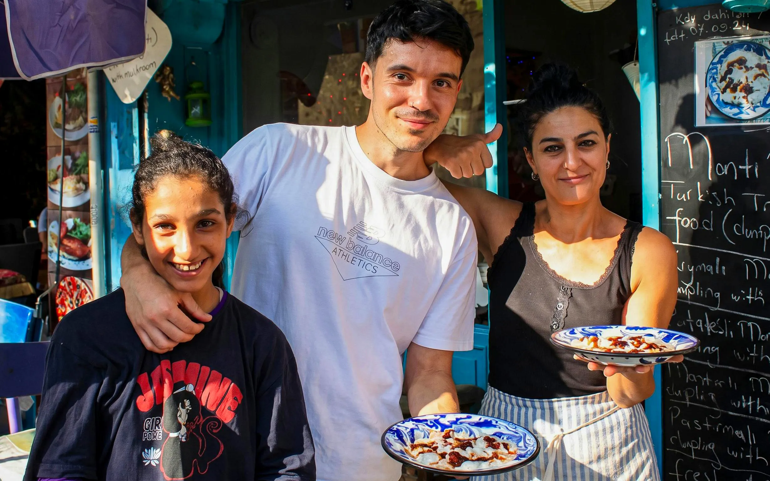 People enjoying traditional Turkish mantı during an Istanbul food tour.