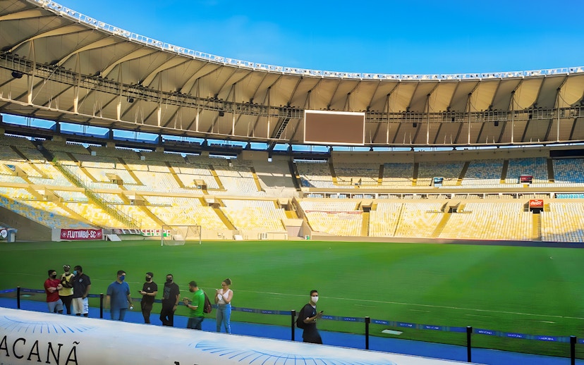 Maracanã Stadium field with visitors walking along the perimeter in Rio de Janeiro, Brazil.