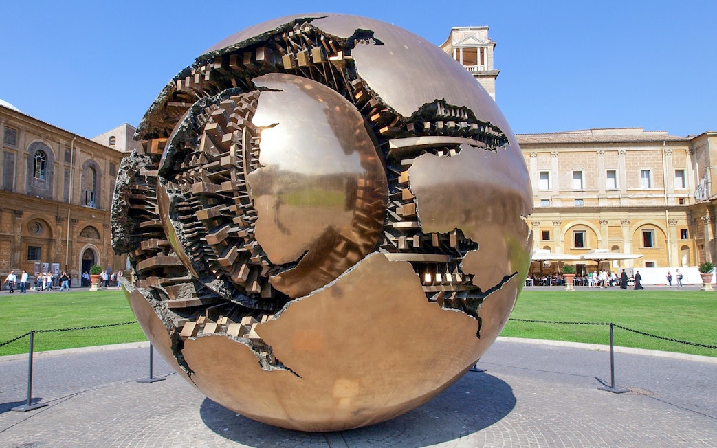 Sculpture of a bronze sphere in the Vatican Museums courtyard, Rome.