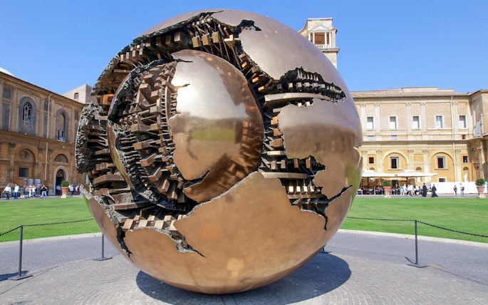 Sculpture of a bronze sphere in the Vatican Museums courtyard, Rome.