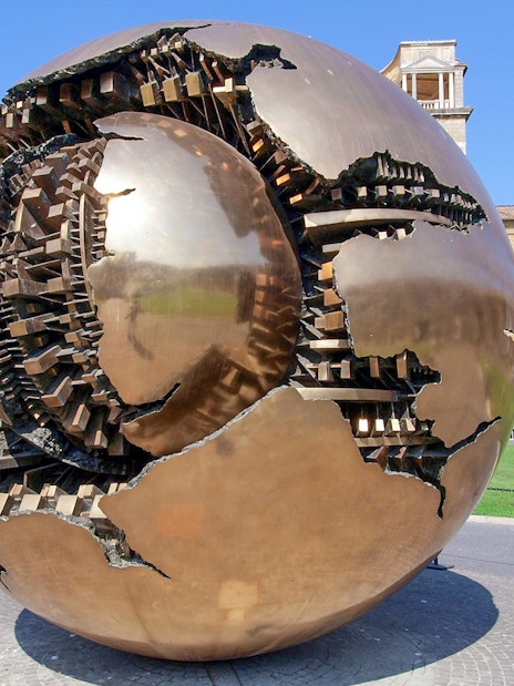 Sculpture of a bronze sphere in the Vatican Museums courtyard, Rome.