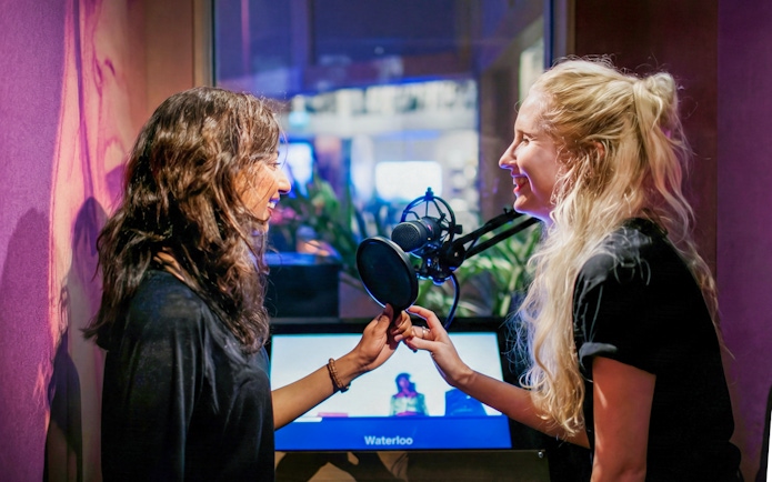 Visitors singing at ABBA Museum's interactive exhibit in Stockholm, Sweden.