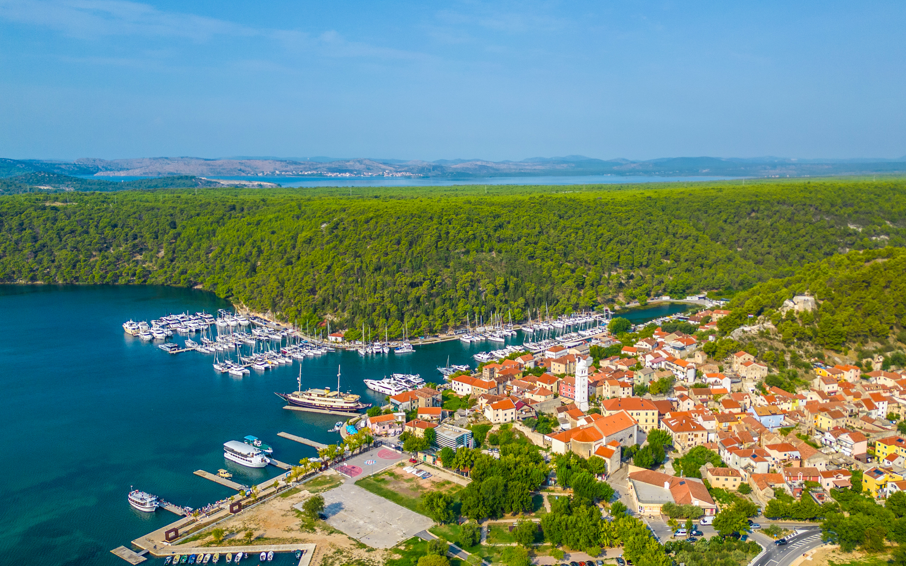 Aerial view of Skradin, Croatia with marina and red-roofed buildings.