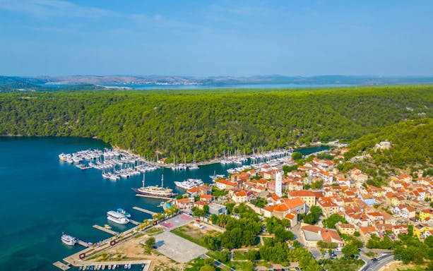 Aerial view of Skradin, Croatia with marina and red-roofed buildings.
