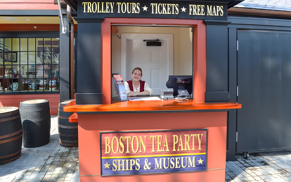 Ticket counter at Boston Tea Party Ships & Museum with staff member.