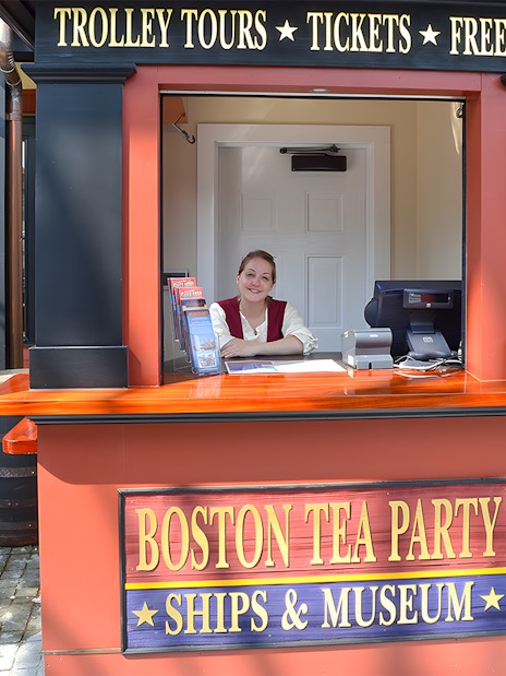 Ticket counter at Boston Tea Party Ships & Museum with staff member.