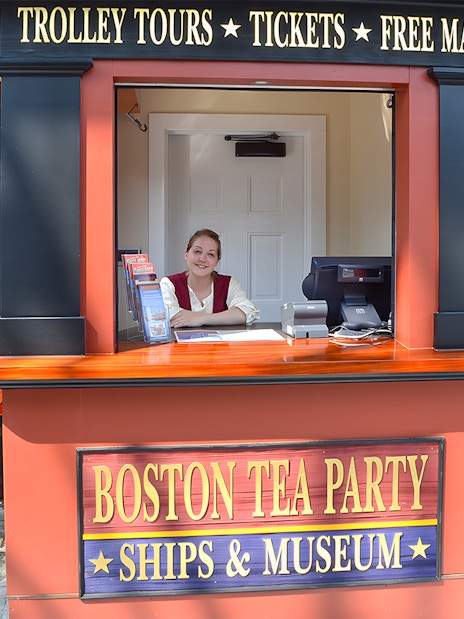 Ticket counter at Boston Tea Party Ships & Museum with staff member.