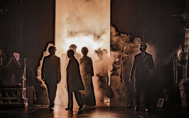 Performers emerging through smoke in Grace Pervades West End show.