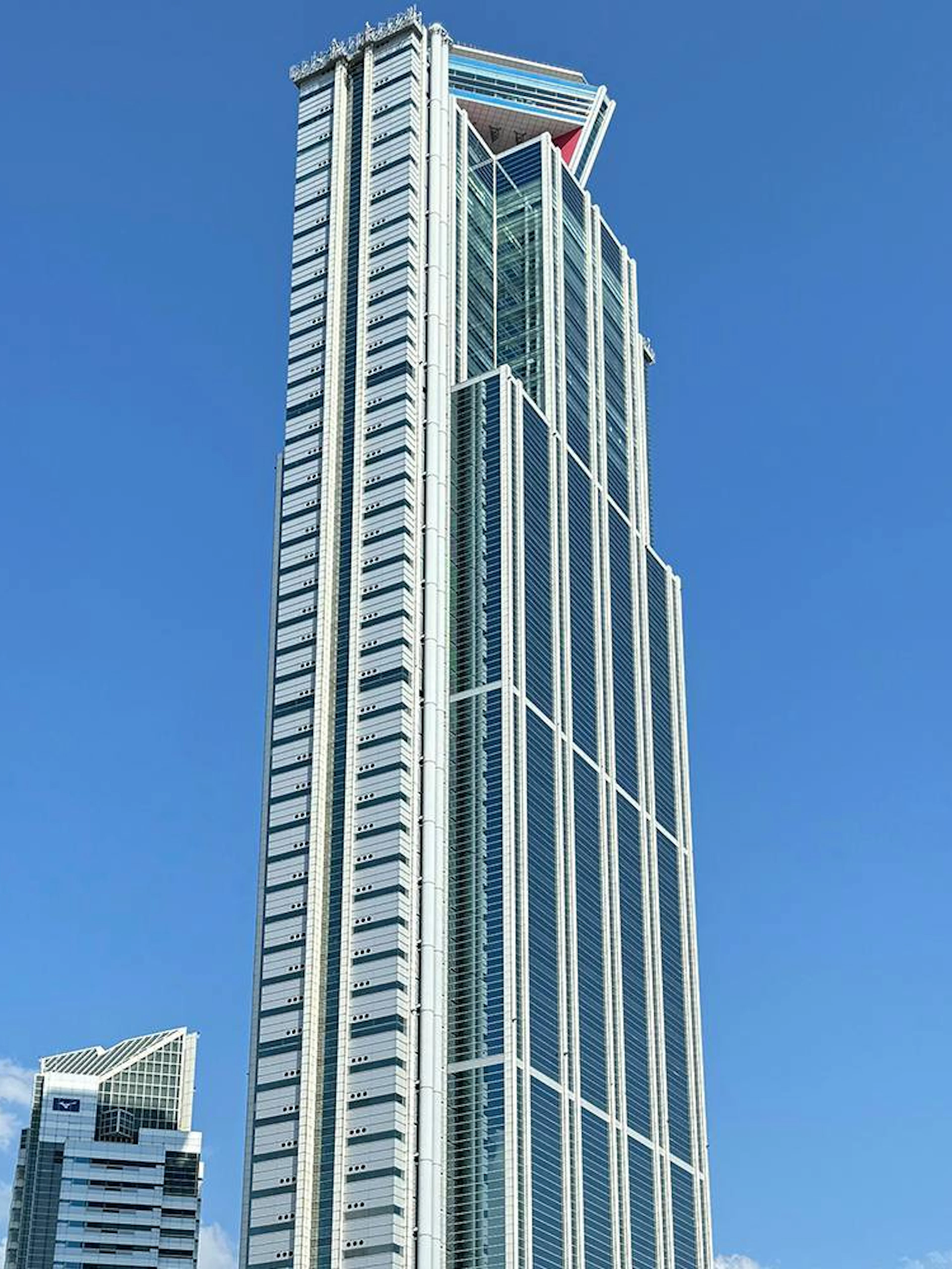 Osaka Sakishima Observatory skyscraper against a clear blue sky.