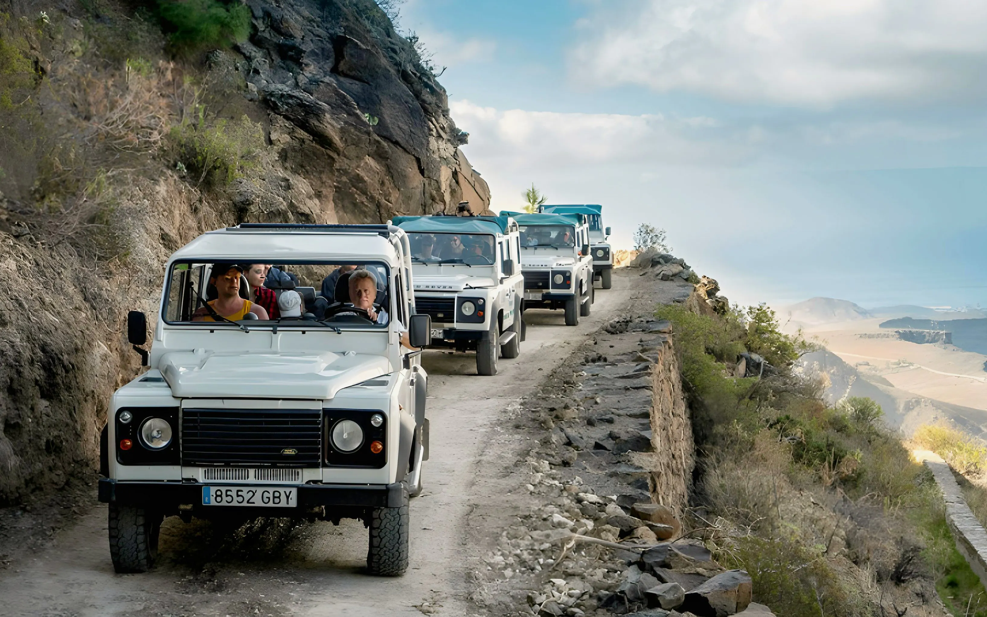 Jeep convoy on a narrow mountain road during Gran Canaria safari tour.