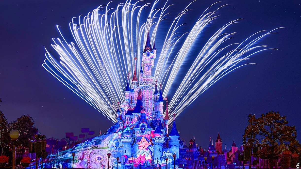 Fireworks display over Sleeping Beauty Castle during Disneyland Paris light show.