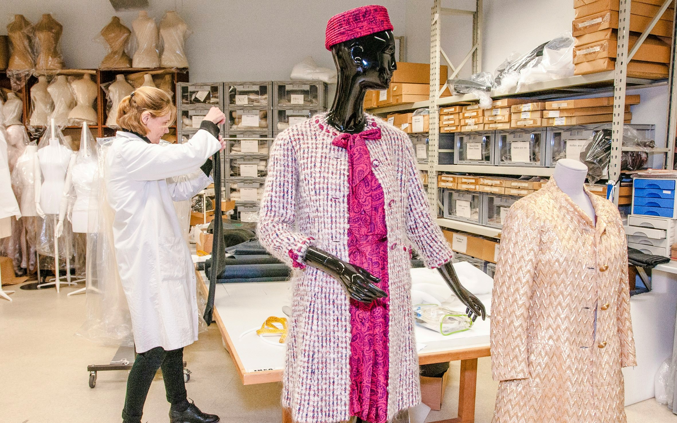 Mannequin in vintage attire at Palais Galliera fashion museum workspace.