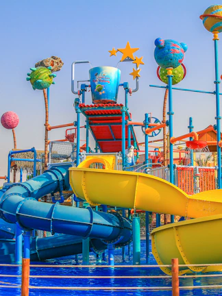 Colorful water slides and play structures at Al Montazah Water Park, Sharjah.