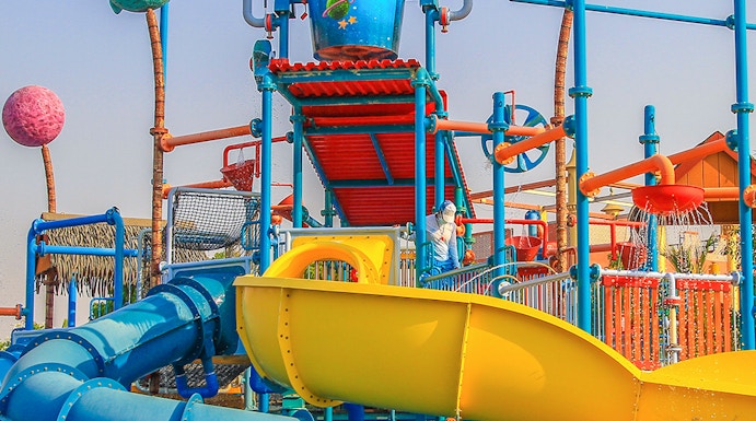 Colorful water slides and play structures at Al Montazah Water Park, Sharjah.