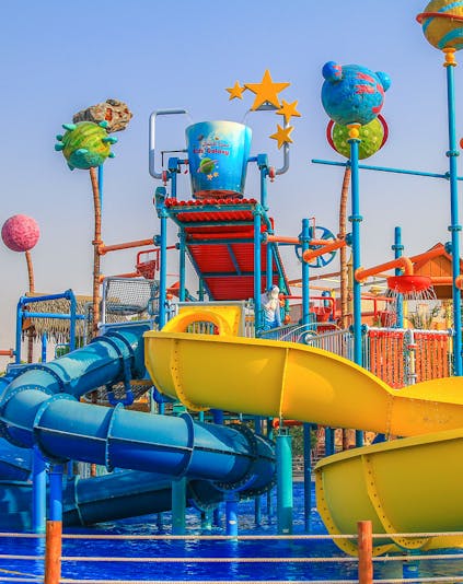 Colorful water slides and play structures at Al Montazah Water Park, Sharjah.