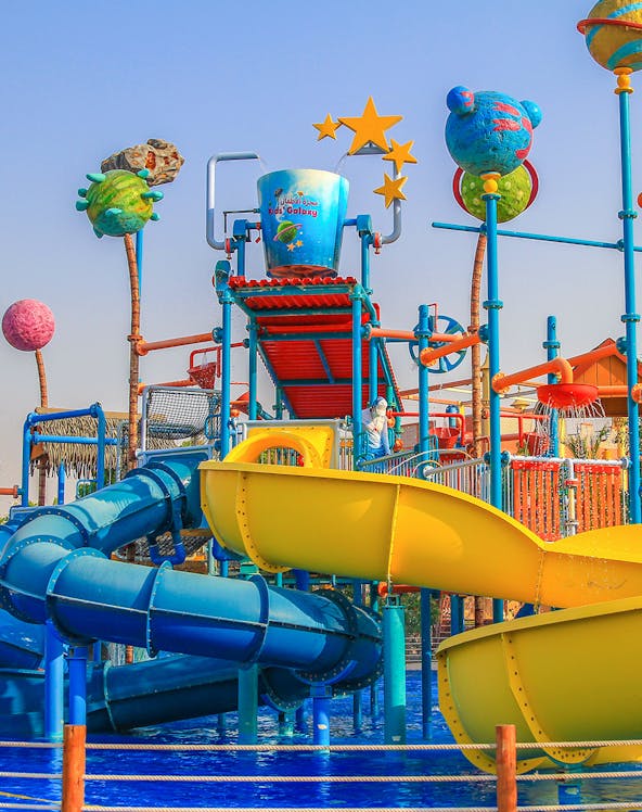 Colorful water slides and play structures at Al Montazah Water Park, Sharjah.