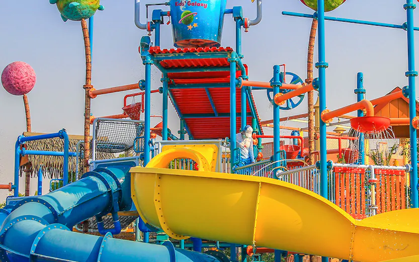 Colorful water slides and play structures at Al Montazah Water Park, Sharjah.