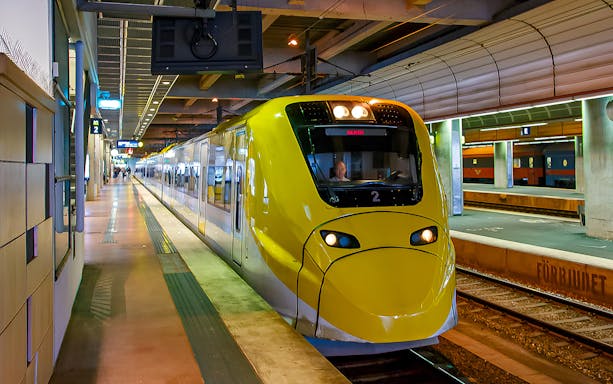 Stockholm Arlanda Express train at underground station platform.