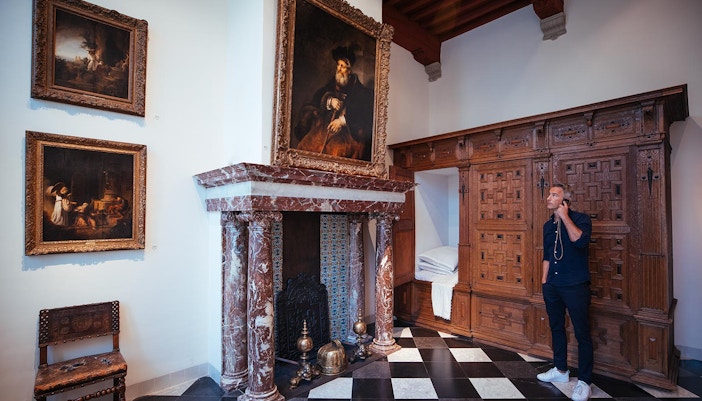 Visitor using multimedia guide at Rembrandt House Museum, Amsterdam.