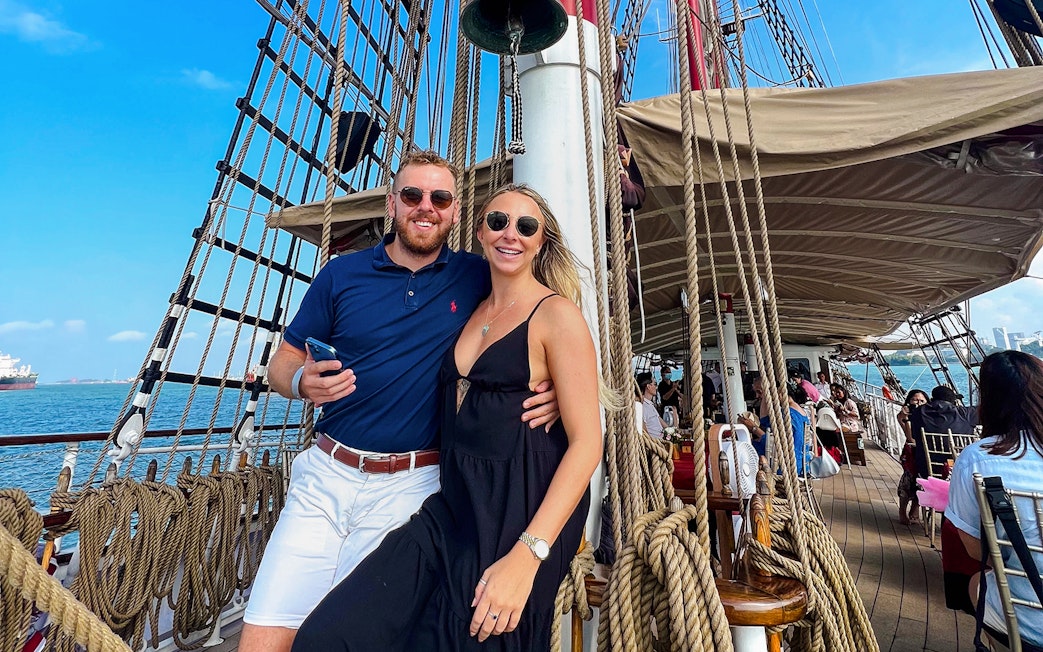 Couple enjoying breakfast cruise on The Royal Albatross with ocean view.
