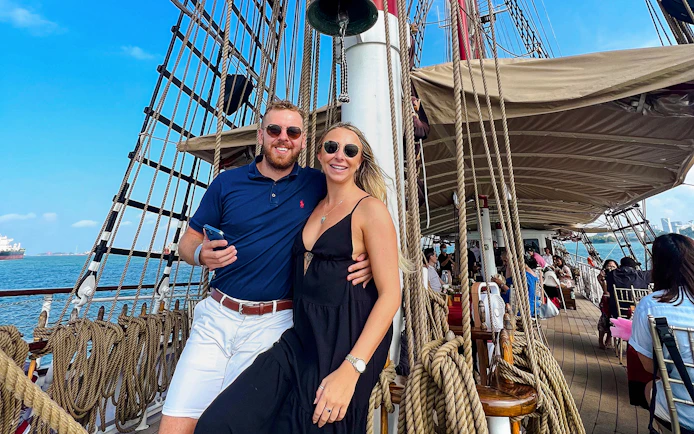 Couple enjoying breakfast cruise on The Royal Albatross with ocean view.