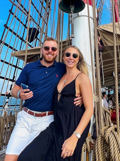 Couple enjoying breakfast cruise on The Royal Albatross with ocean view.