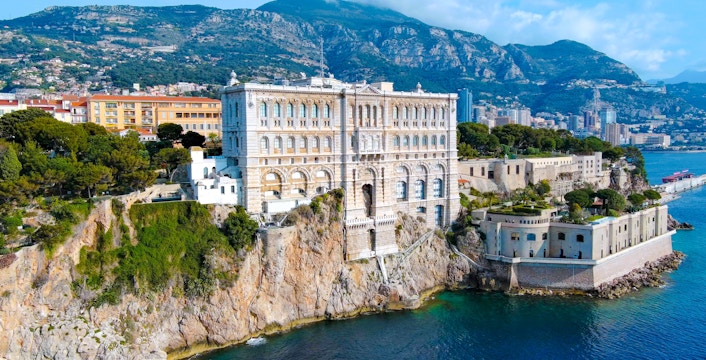 Aerial view of Monaco's Oceanographic Museum perched on a cliff overlooking the Mediterranean Sea.