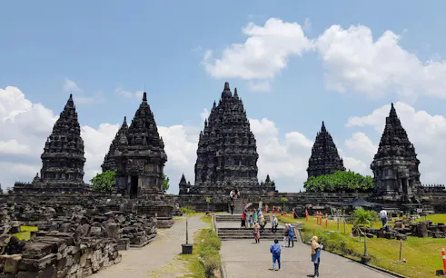 Prambanan Temple complex with visitors exploring ancient stone structures in Yogyakarta, Indonesia.