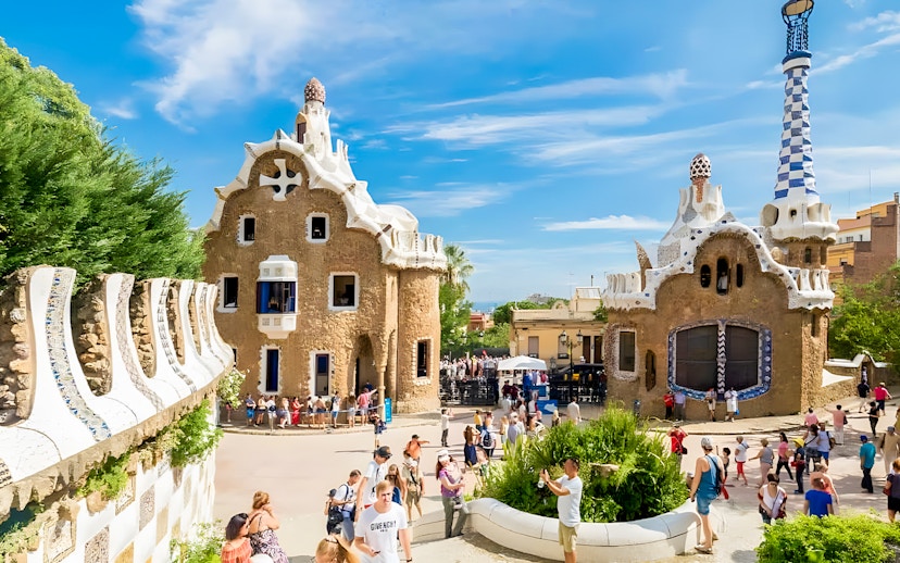 Park Güell entrance houses with tourists in Barcelona, Spain.