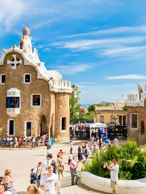 Park Güell entrance houses with tourists in Barcelona, Spain.