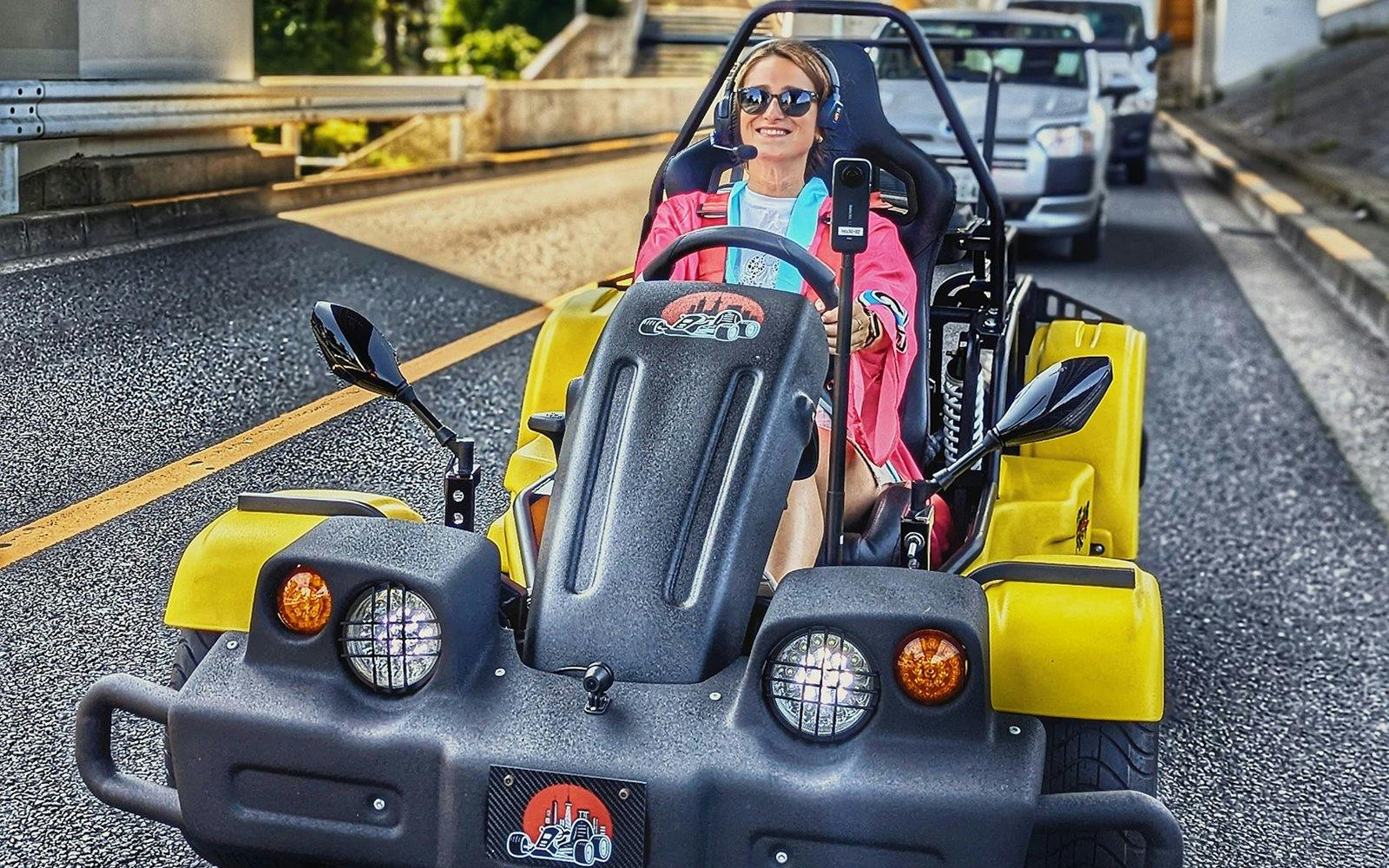 Person driving a yellow go-kart on Uptown Go Kart Tour.