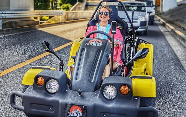 Person driving a yellow go-kart on Uptown Go Kart Tour.