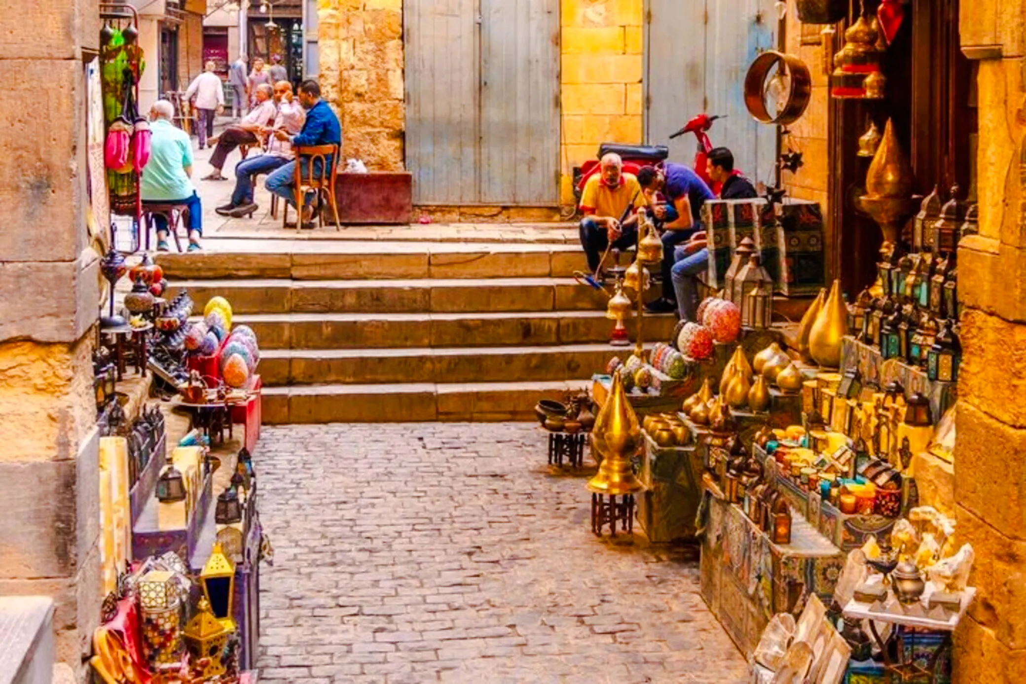 Market stalls with brass lamps and colorful goods in Khan el-Khalili, Cairo.